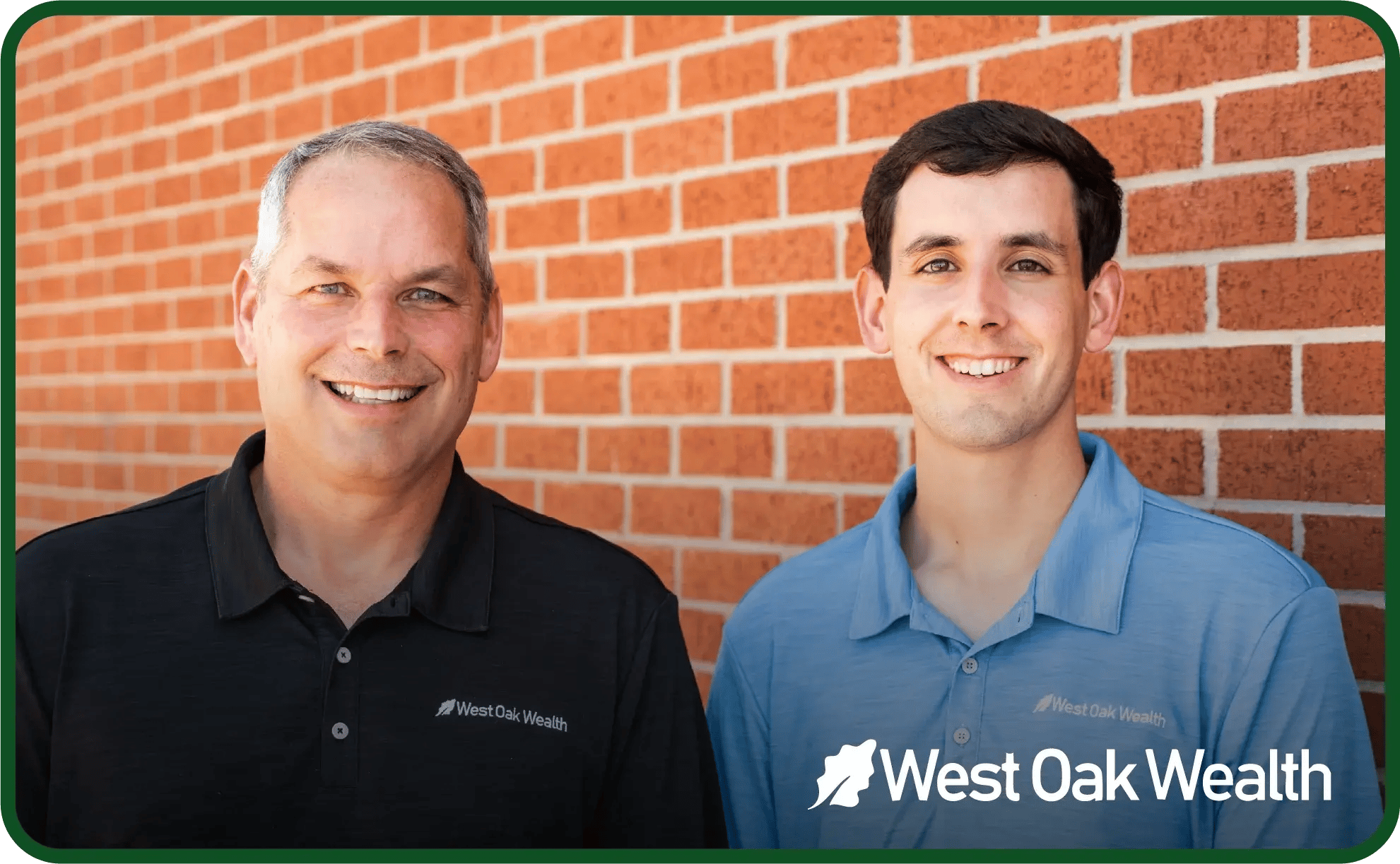 Two men standing in front of a brick wall. 