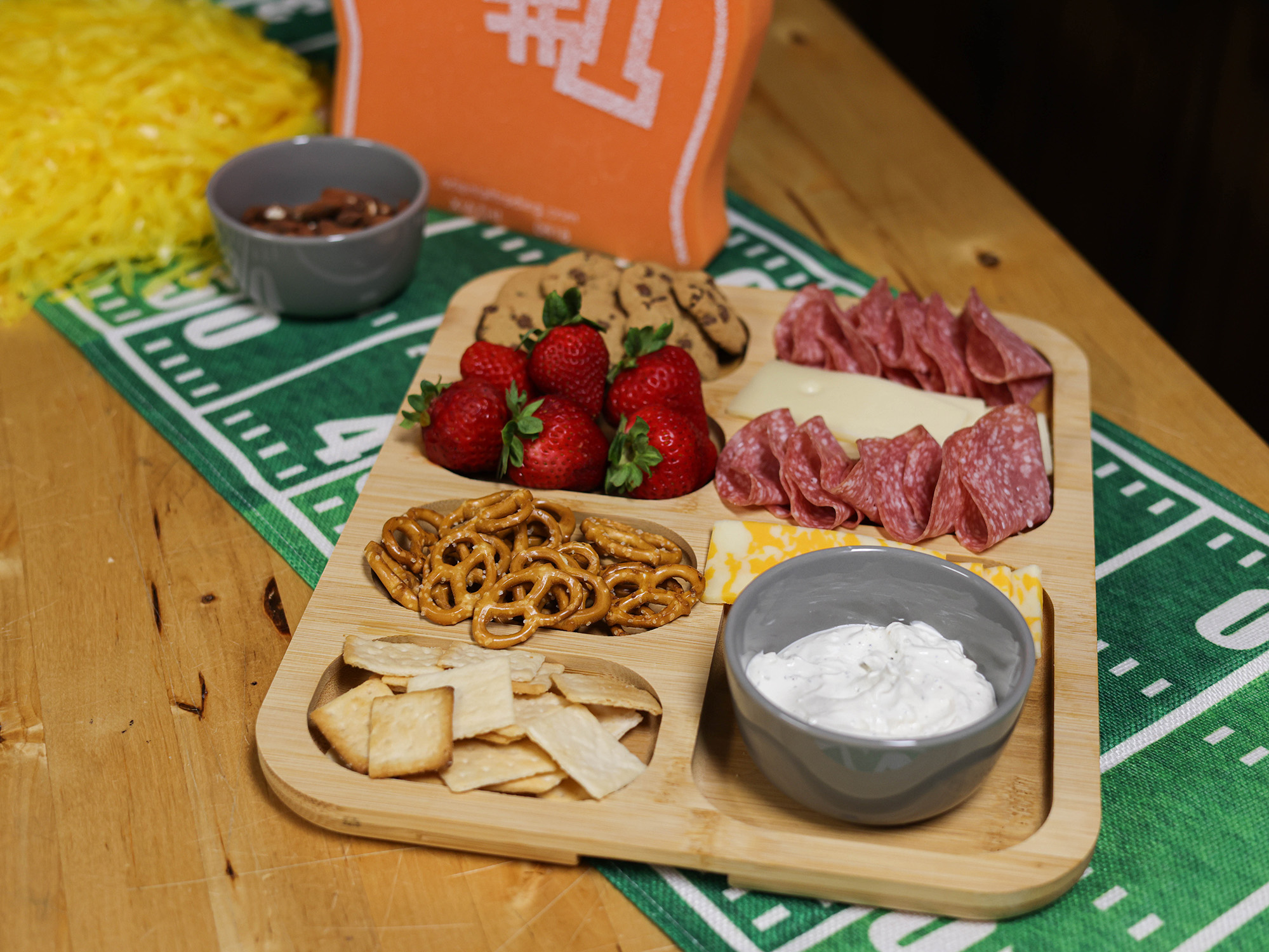charcuterie board with crackers, cheeses, meats, fruit, and cookies